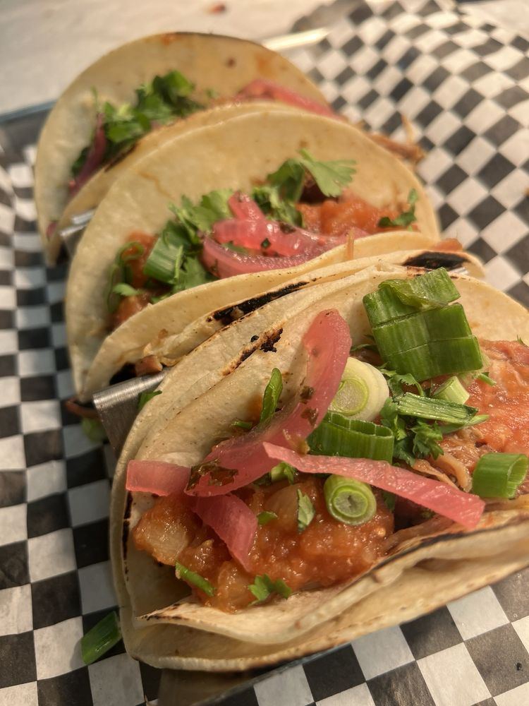 Hula-Q riblet tacos with pineapple salsa, pickled onions and green onions