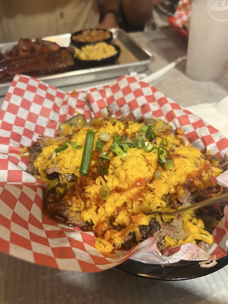 Loaded BBQ potato with cheese and green onions